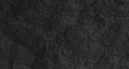 Torn crumpled black paper background