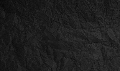 Torn crumpled black paper background