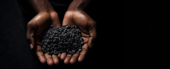 Slavery in mining. African hands holding coltan grains over dark background with copy space - obrazy, fototapety, plakaty