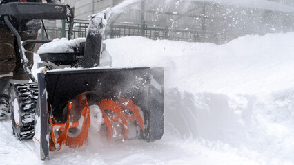 a man cleans snow with a snow plow outside