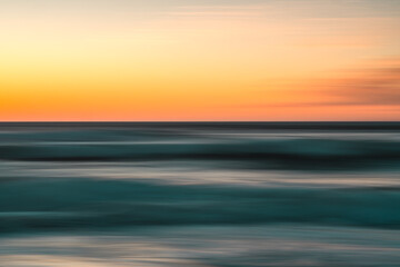 Fototapeta premium Creative abstract background. Sea and sky at sunset, motion blur