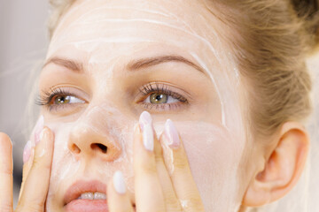 Girl apply facial cream cosmetic