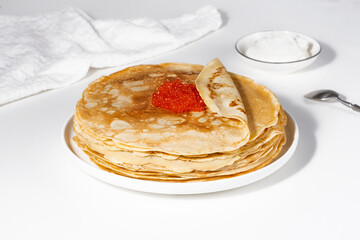 Pancakes with red caviar,Close-up of pancakes stacked on white background