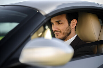 Confident businessman in luxury car