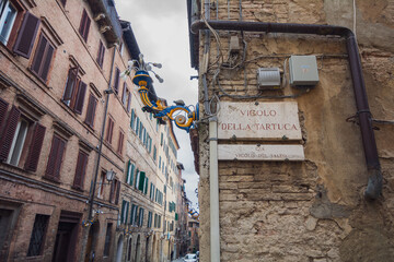 Contrada della Tartuca's street in Siena, italy - obrazy, fototapety, plakaty