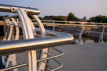 Waterfront railing in a downtown setting at sunset.