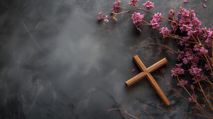 Refined gray marble background adorned by a wooden cross and delicate pink flowers, harmonizing elegance and spirituality