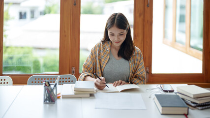 Self learning concept. Young woman student  university Researching Book In Library. University Student