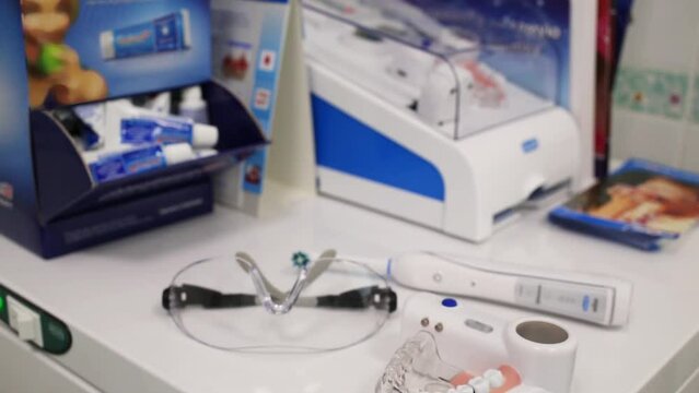 Modern model of jaw, glasses and electrical toothbrush are laying 