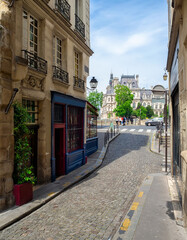 View of old narrow street in Paris, France. Cozy cityscape of Paris. Architecture and landmarks of Paris. - obrazy, fototapety, plakaty