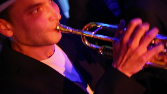 Musicians with trumpet, guitar and sax of band are playing music