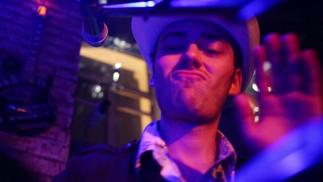 Musician of band in white hat is playing on bongo at musical bar MUSE.