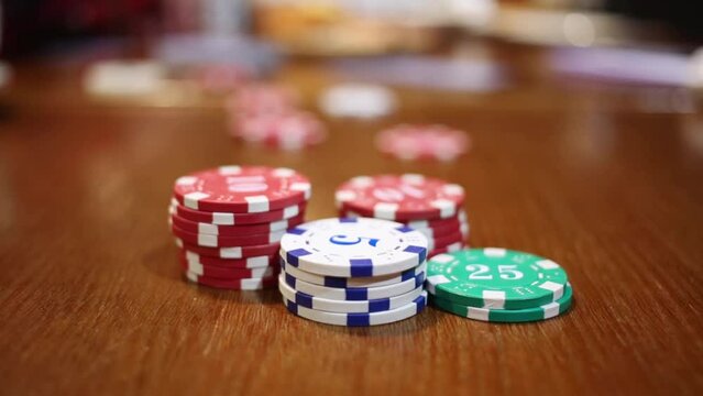 Column of fish (focus on its) and hand move one at table in poker game