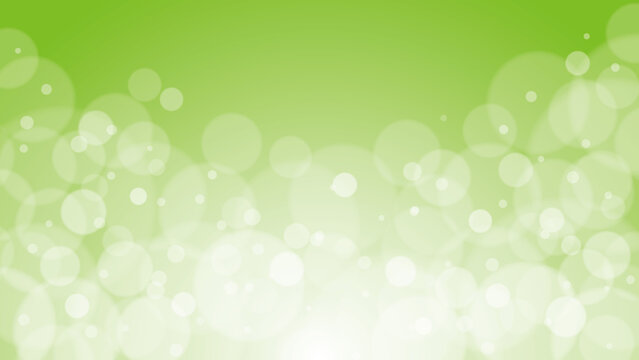 Shiny bokeh particles glittering on light green background