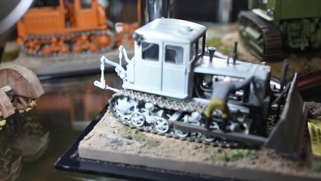 Earthmovers are standing on the platform and moving at exhibition