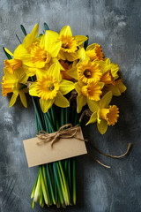 Bouquet of fresh daffodil flowers and thank you tag on concrete background. Generative AI - 722424352
