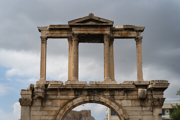 Arch of Hadrian in the center of Athens against the background of the sky with clouds.