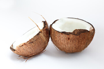 Ripe coconuts and half coconut on white background