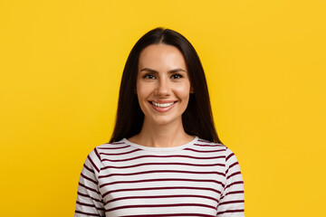 Portrait Of Beautiful Young Caucasian Woman Posing Over Yellow Background