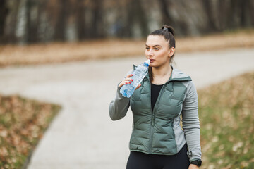 Woman Holding Bottle of Water - Hydration and Health Concept