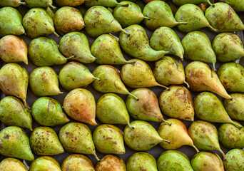 Fresh pears, elegantly arranged in the market, dazzle with their color and freshness.