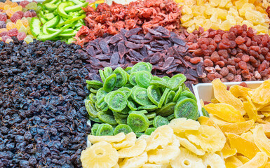 Mountain of dried fruits in a market, intense colors and appetizing textures create a healthy feast.