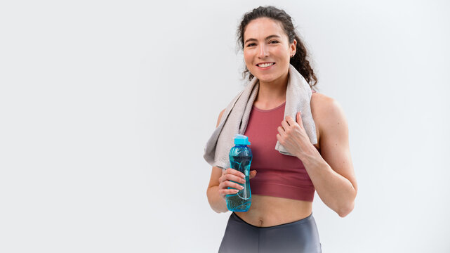 Banner view of sporty smiling woman in sportswear and towel on neck