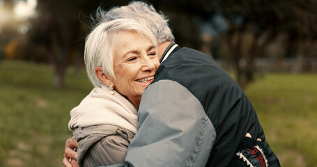 Love, nature and smile with a senior couple hugging outdoor in a park together for a romantic date...