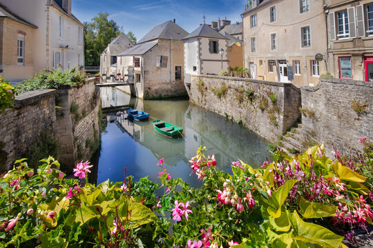 Old Buildings along the quiet Aure River in the medieval old town of Bayeux, France 