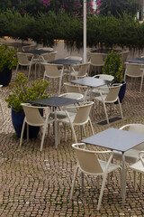 Empty cafe terrace in Lisbon, Portugal. Outdoor restaurants of Alfama district. 
