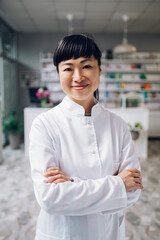 Close up of a Japanese druggist posing in an apothecary.