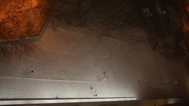 Road with patterns trampled by feet between building and trees