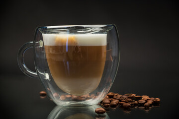 hot coffee with milk on black background