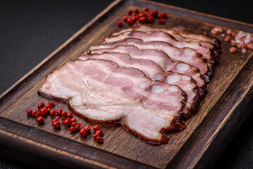 Delicious fresh pancetta or bacon with salt and spices cut into thin slices