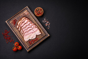 Delicious fresh pancetta or bacon with salt and spices cut into thin slices