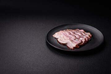 Delicious fresh pancetta or bacon with salt and spices cut into thin slices