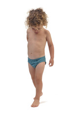 front view of a baby boy  walking and looking down on white background
