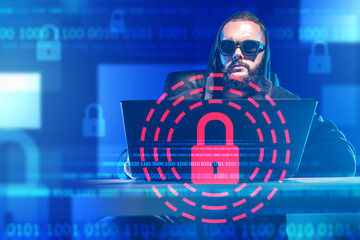 Male hacker. Lock near computer burglar. Hacker in hood at table with laptop. Programmer hacks site...