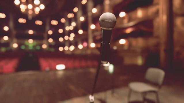 An Intimate Opera Performance on an Empty Stage with Microphone and Chairs