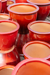 Bright red ceramic plant pots at local nursery.
