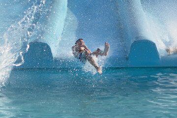 Man Riding Water Slide in Pool