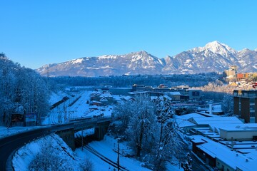 Train station in the town of Kranj, Gorenjska, Slovenia and mountains in the background in winter