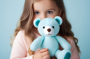 Crochet blue bear and little girl. Cute handmade toy. Japanese amigurumi