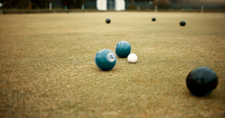 Green, balls and lawn bowling game on grass, field or pitch in a match or competition of outdoor...