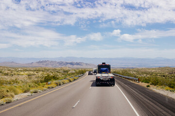 Beautiful blue sky with fluffy clouds over the highway. Scenic road in Arizona, USA on a sunny summer day. 40 hwy, 10 hwy in Arizona, USA - 17 April 2020