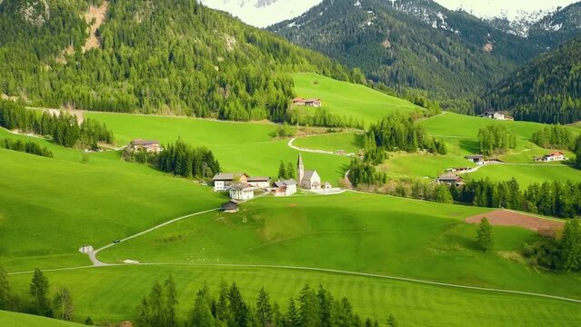 Spring sunny landscape of alpine meadow in Dolomites Alps. Famous Santa Maddalena village with church and beautiful Dolomiti mountains, Val Di Funes, Dolomites, South Tyrol, Italy