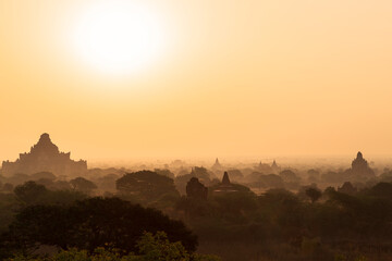 Scenic landscape and silhouette of many ancient temples and pagodas at the plain of Bagan in Myanmar (Burma) at sunrise. - obrazy, fototapety, plakaty