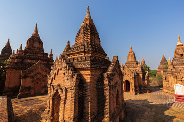 View of several old small pagodas in Bagan, Myanmar (Burma), on a sunny day.