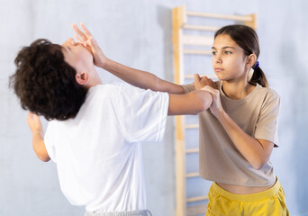 Children in sparring improve skill of performing strangulation and neutralizing enemy during krav...