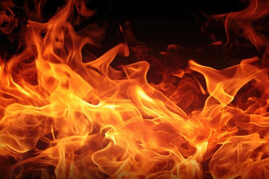 A close-up view of a fire burning on a black background. This image can be used to represent warmth, energy, or danger in various creative projects